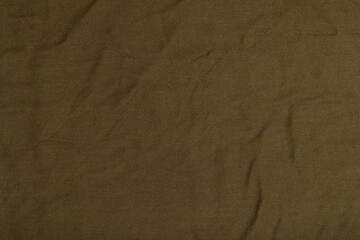 Dark textile background with wrinkles. Fabric texture.