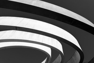 Striking monochrome architectural feature with sweeping curves and a dynamic interplay of light and shadow