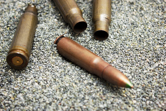 Cartridge  for rifle and empty cartridge founds lying on the sand