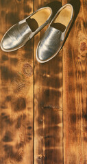 Original shiny shoes in disco style lie on a vintage wooden surface made from fried brown boards....