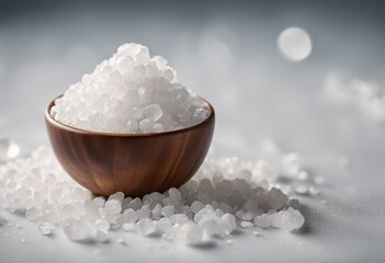 Coarse sea salt in wooden bowl on white background