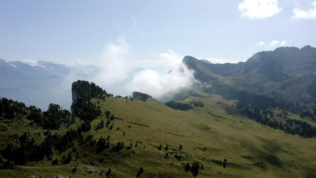 Aerial Panning Scenic Shot Of Green Mountains In Clouds On Sunny Day - Chambery, France
