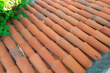 Antique clay roof made of semicircular tiles. Background with selective focus and copy space