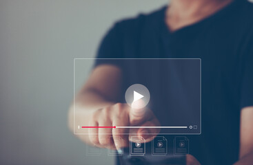 Video streaming on the Internet. Man using mobile phone for watching movies, live event, tutorial and listening to music online on popular online platforms. Marketing technology, website advertising. - obrazy, fototapety, plakaty