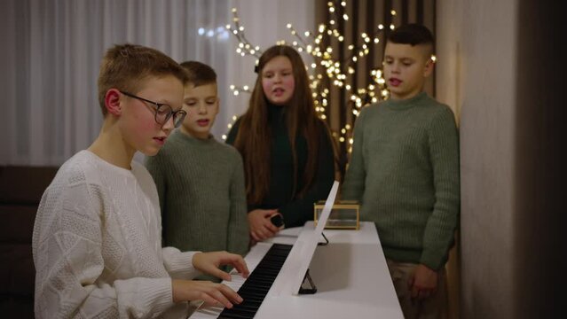 Children play the piano and sing