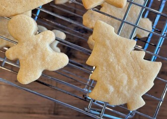 Christmas sugar cookies on a cooling rack ready to be iced