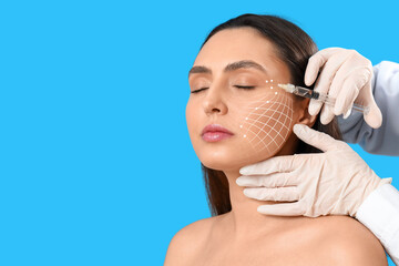 Young woman receiving filler injection in face against light blue background. Skin care concept