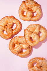 Tasty pretzels on pink background