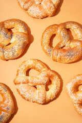 Delicious pretzels on color background