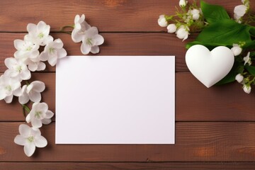 White card with flowers and heart on wooden background