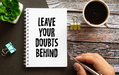 Leave your doubts behind - handwriting on a napkin with a cup of espresso coffee?