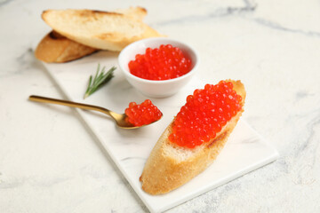 Tasty bruschettas with red caviar on grunge background
