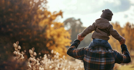 dad holding a kid on his shoulders outside