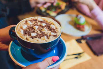 Mug of hot chocolate with marshmallows on table.