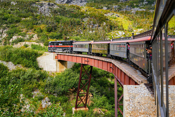 Narrow-gauge train of the White Pass and Yukon Route in the Alaskan mountains between Skagway and...