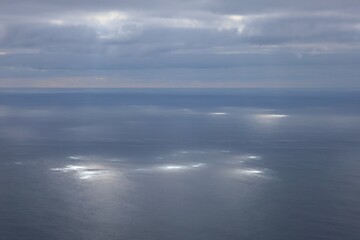 Fototapeta premium Clouds over the sea with sunstreak on the water surface