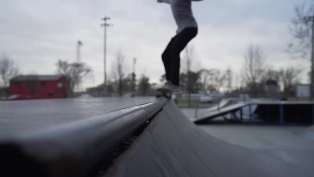 skateboarding man grinding on halfpipe
