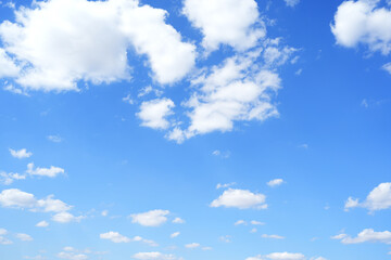 Blue sky background with fluffy clouds in summer