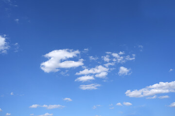 Blue sky background with fluffy clouds in summer