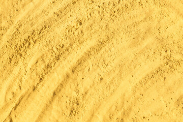 Texture of yellow sand as background, closeup