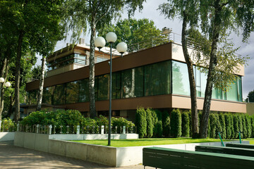 View of modern house with green trees in city