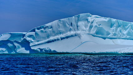 Beautiful blue icebergs in the North Atlantic Ocean off the entrance to Twillingate harbor in...
