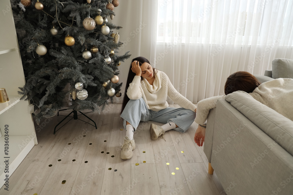 Sticker young woman with hangover sitting after new year party at home