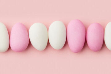 Traditional Easter Portuguese candies. White and pink sweets on pastel pink background