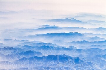 Beijing, China - July 17 2010 : mysterious looking morning fog hangs deep in the valleys and only mountain summits are visible - obrazy, fototapety, plakaty