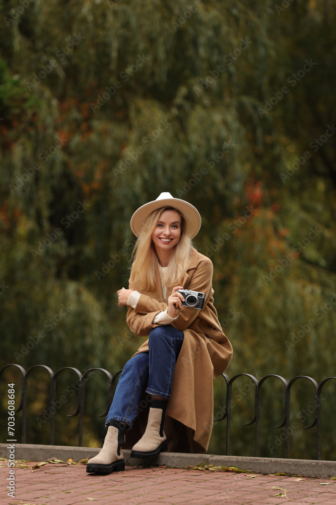 Canvas Prints Happy woman with camera in autumn park