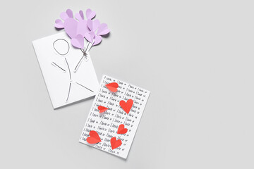 Greeting cards for Valentine's Day celebration on grey background