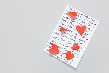 Card with text I LOVE U and red hearts on grey background. Valentine's Day celebration