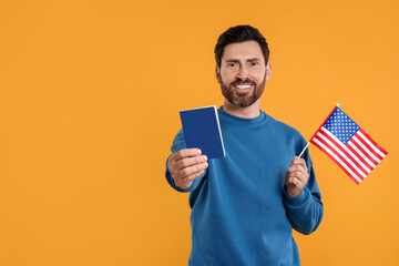 Immigration. Happy man with passport and American flag on orange background, space for text
