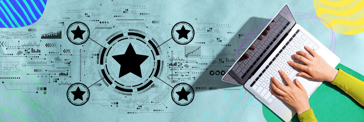 Rating star concept with person using a laptop computer