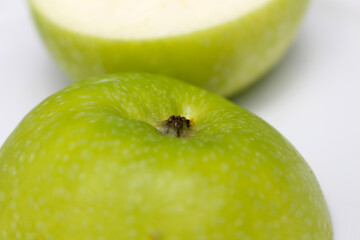 green apple close up. apple with selective focus. green apple cut in half.