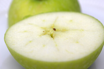 green apple close up. apple with selective focus. green apple cut in half.