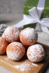 Delicious sweet buns with powdered sugar on table, closeup