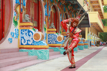 A young Asian man  dressed as a monkey king participates in the Chinese New Year parade, Chinese...
