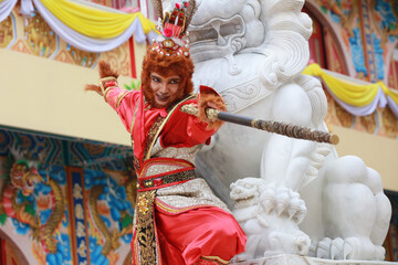 A young Asian man  dressed as a monkey king participates in the Chinese New Year parade, Chinese...