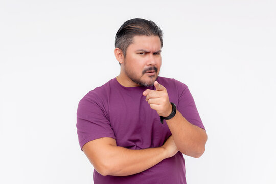A doubtful man asking questions to someone, pointing with his fingers. Looking very distrustful. Wearing a purple waffle shirt, Isolated on a white background.