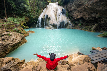 Happiness tourist looking to beautiful view of Koh Luang Waterfall in Maeping National Park of...
