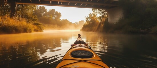 Canal kayaking with calm waters and mist near bridges. - obrazy, fototapety, plakaty