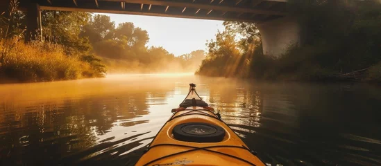 Foto op Canvas Canal kayaking with calm waters and mist near bridges. © 2rogan