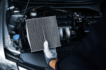 Hand mechanic holding car air conditioner filter for check and clean dirty or fix repair heat have...