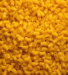A pile of yellow plastic beads. Generative AI.