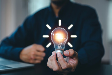 Hand and light bulb for creative idea concept or innovation of technology in analyzing global...