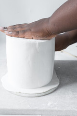 Covering a cake with fondant, paneling a Styrofoam cake dummy with fondant icing