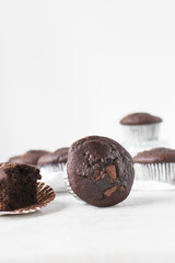Double chocolate muffins on a white marble tray, dark chocolate muffins with a white background