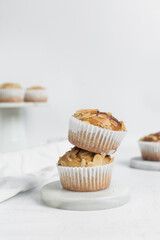 almond muffins on a white marble tray, homemade bakery style almond muffins on a white background