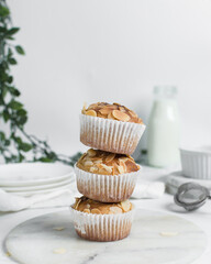 almond muffins on a white marble tray, homemade bakery style almond muffins on a white background